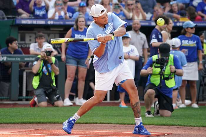 Patrick Mahomes swings the bat during a celebrity softball game.